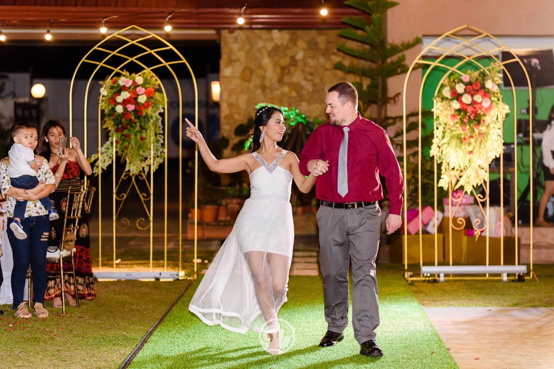 Wedding couple entering the garden reception