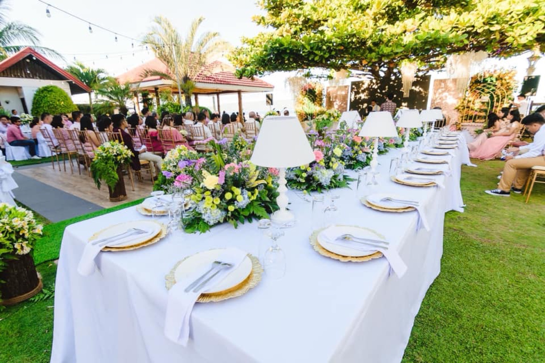 Garden banquet table styled with white linens and flowers