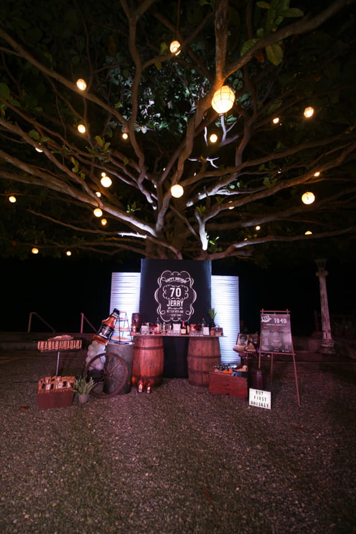 Seventieth birthday stage beneath the illuminated tree