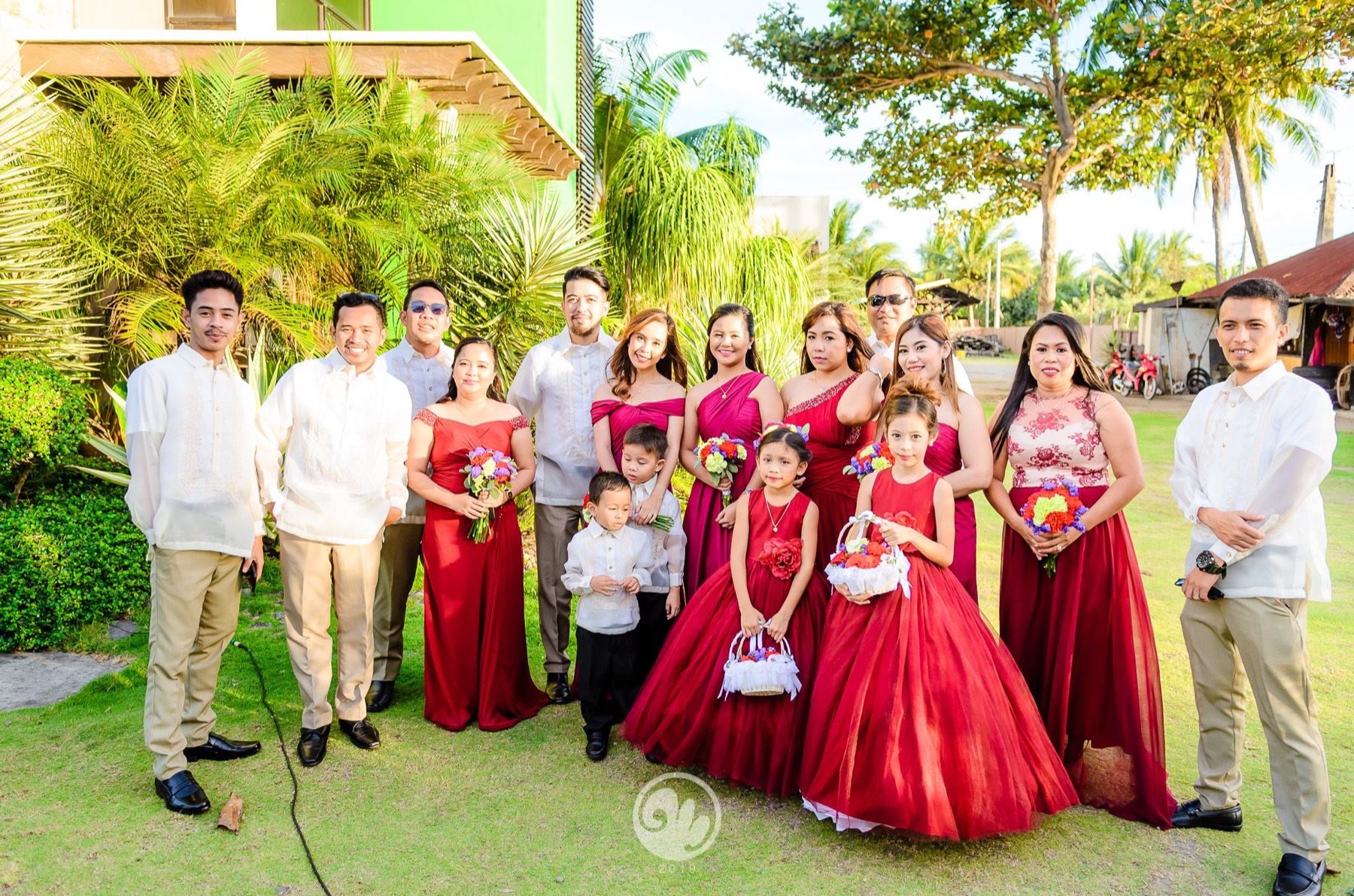 Wedding party in coordinated red formal attire